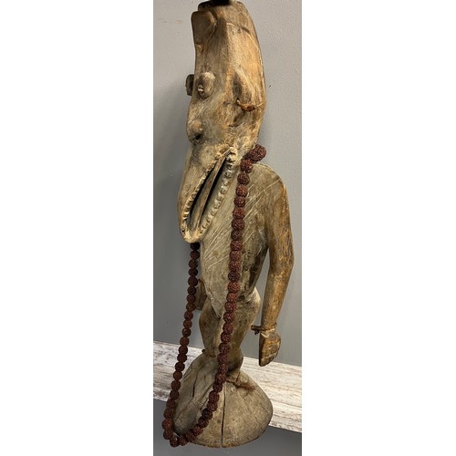 550 - Antique hand carved African Tribal Figure, Elongated face, comes with nut necklace. [72cm high]