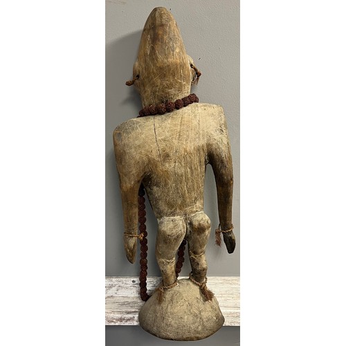 550 - Antique hand carved African Tribal Figure, Elongated face, comes with nut necklace. [72cm high]