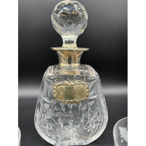 592 - A Crystal decanter with a London silver collar and Sheffield silver drinks label. Together with two ... 