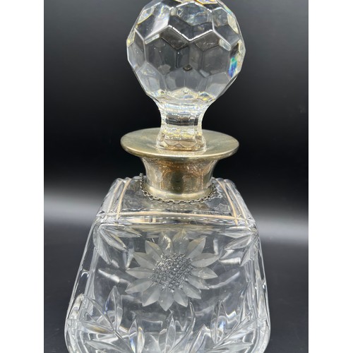 592 - A Crystal decanter with a London silver collar and Sheffield silver drinks label. Together with two ... 