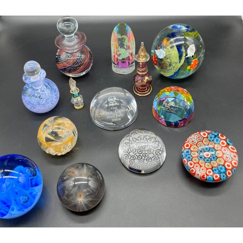 593 - A Selection of mixed art glass paperweights. Includes two perfume bottles.