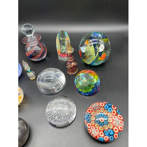 593 - A Selection of mixed art glass paperweights. Includes two perfume bottles.