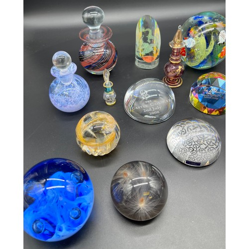 593 - A Selection of mixed art glass paperweights. Includes two perfume bottles.