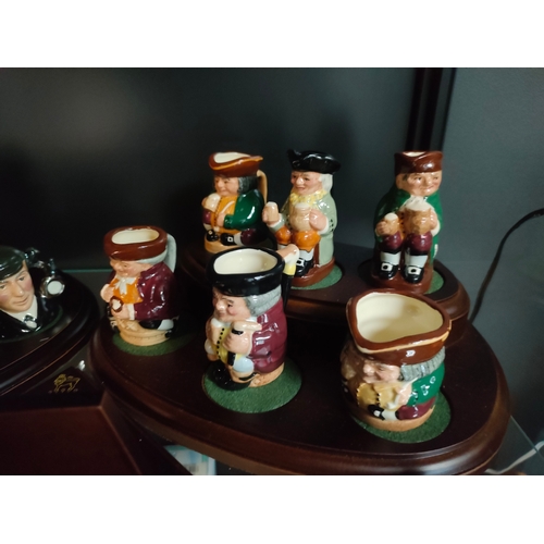 841 - A Collection of miniature Royal doulton Toby jugs on display plinths to include doctor Watson , prof... 