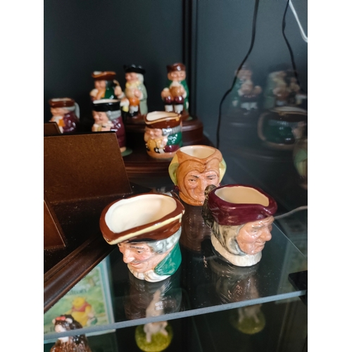 841 - A Collection of miniature Royal doulton Toby jugs on display plinths to include doctor Watson , prof... 