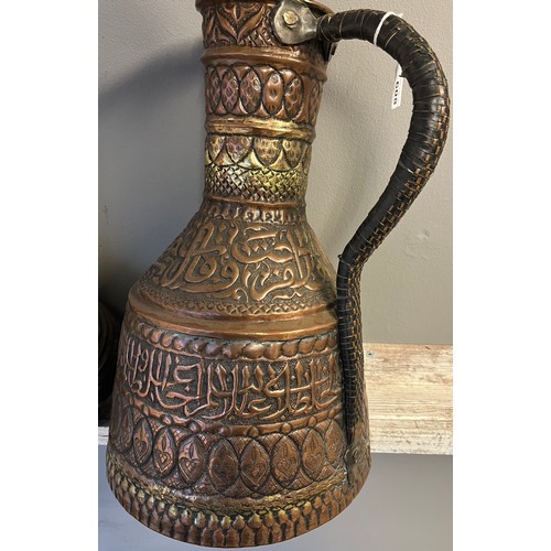 608 - Antique Persian style copper/ brass worked water carrier with leather bound handle. Together with br... 