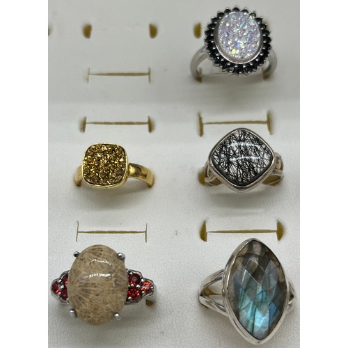 534 - A Lot of seven 925 silver rings set with various gem stones.