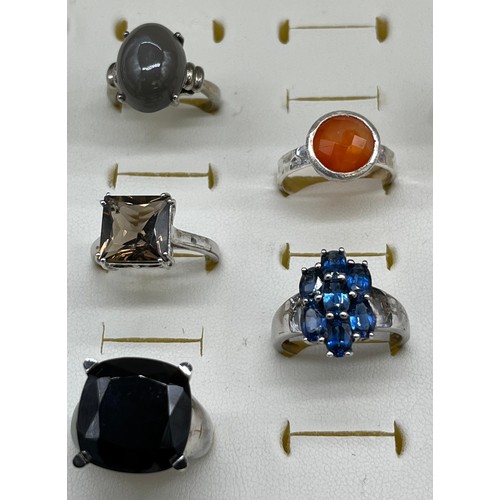 535 - A Collection of eight 925 silver and gem stone rings.