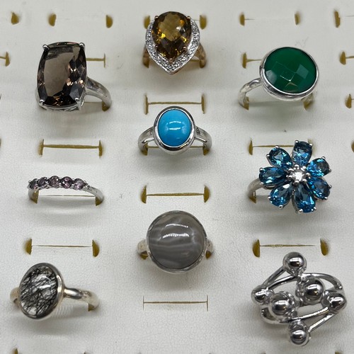 536 - A Collection of Nine 925 silver and gem stone rings.