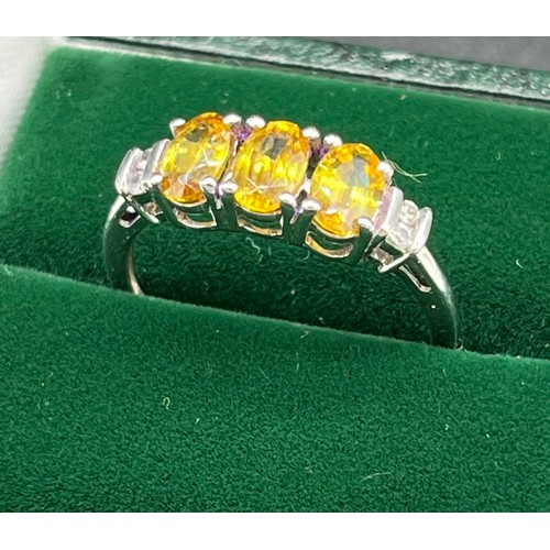 539 - 10ct white gold ladies ring set with three yellow tourmaline oval stones off set by white topaz ston... 