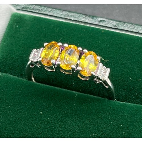 539 - 10ct white gold ladies ring set with three yellow tourmaline oval stones off set by white topaz ston... 