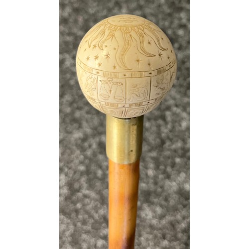 824 - Bamboo walking cane fitted with a hidden blade. Resin sphere handle engraved with sun and star signs... 