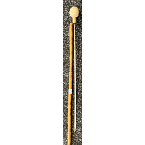 824 - Bamboo walking cane fitted with a hidden blade. Resin sphere handle engraved with sun and star signs... 