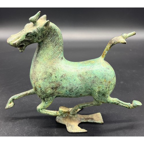 615 - A bronze sculpture of the flying horse of Gansu . Signed to the inside. [16cm high]