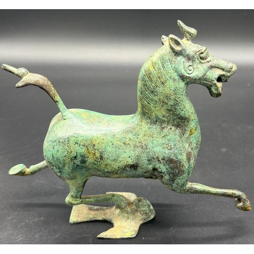 615 - A bronze sculpture of the flying horse of Gansu . Signed to the inside. [16cm high]