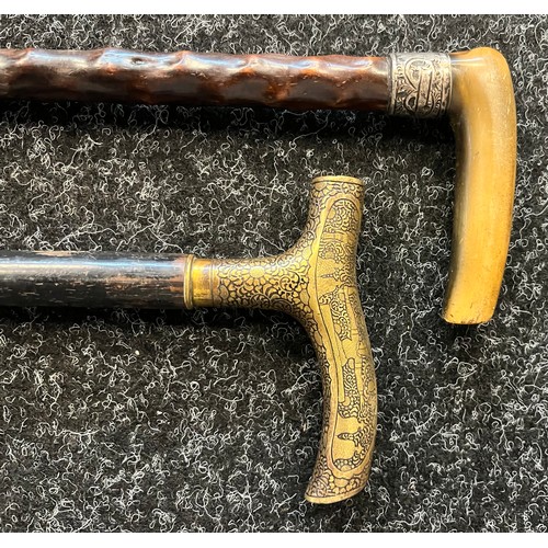 727 - Two vintage walking canes to include horn and silver top handle and brass engraved handle.