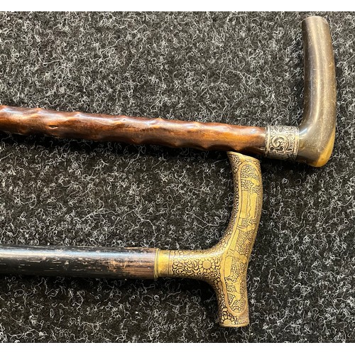 727 - Two vintage walking canes to include horn and silver top handle and brass engraved handle.