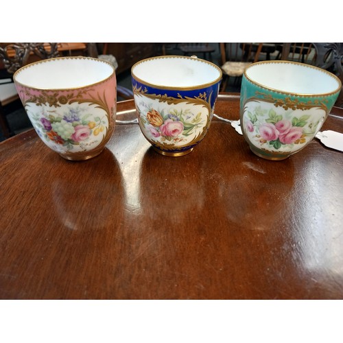 742 - A lot of three Antique hand painted cups and saucers. Detailed with gilt trims and bouquets of hand ... 