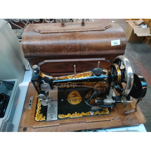 363 - Serata hand crank sewing machine, body is designed with gold trims and lions