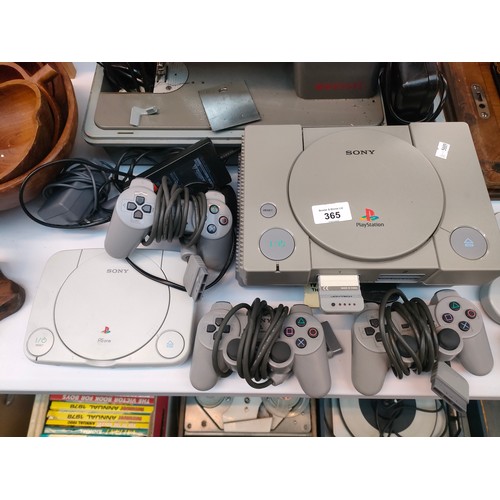365 - Two original Playstation one consoles together with a Sony PS One. With controllers and one power le... 