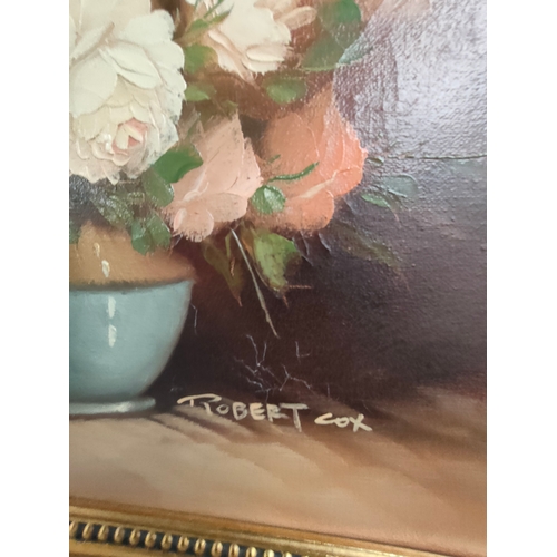 98E - Oil painting depicting flowers in vase signed signed Robert cox in fitted gilt framing .