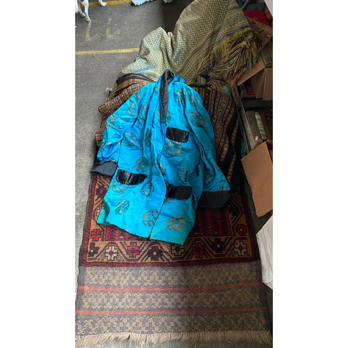 91 - A Vintage wicker basket containing oriental kimono silk robe , eastern rugs & throws etc