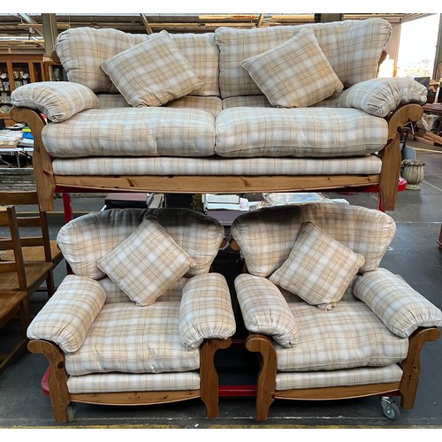 347 - A Pine Ducal three piece sofa set. Cream tartan design material upholstery cushions.