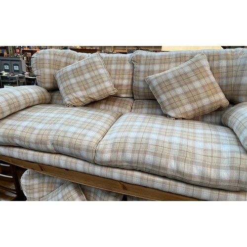 347 - A Pine Ducal three piece sofa set. Cream tartan design material upholstery cushions.