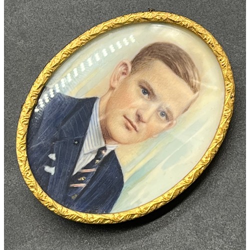 27J - Antique gilt metal brooch fitted with a hand painted portrait of a well-dressed gentleman. [5.5x2.5c... 