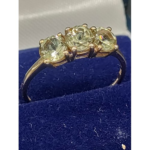 29 - 10ct yellow gold ladies ring set with three green topaz stones. [Ring size P] [1.64Grams]