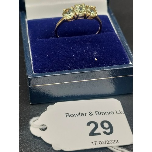 29 - 10ct yellow gold ladies ring set with three green topaz stones. [Ring size P] [1.64Grams]