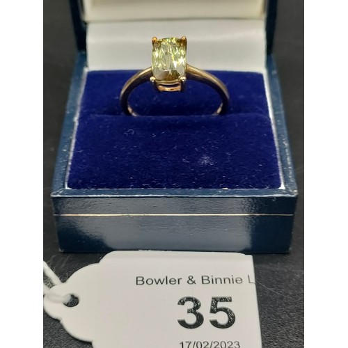 35 - 10ct yellow gold ladies ring set with a large green topaz stone. [Ring size P] [2.36Grams]