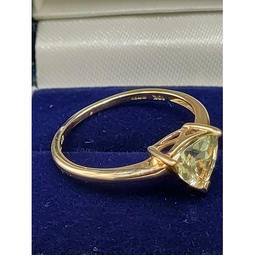 55 - 10ct yellow gold ladies ring set with a single green topaz stone. [Ring size P] [1.89Grams]