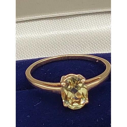 56 - 10ct yellow gold ladies ring set with a single green topaz [Ring size Q] [1.66Grams]