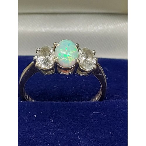 42 - 9ct yellow gold ladies ring with a single opal stone off set by CZ Stones. [Ring size O] [2.55Grams]