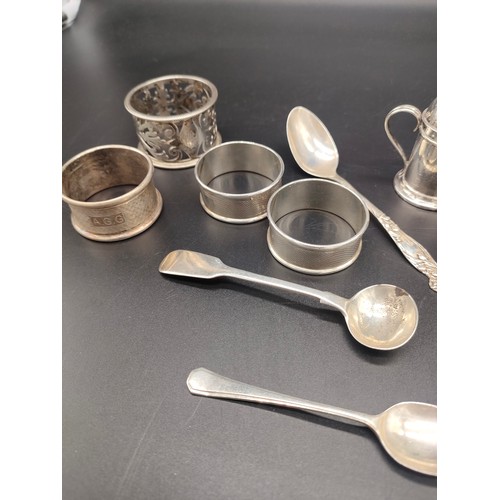 27 - A Collection of silver marked items to include four napkin rings, Two silver pepper pots, Victorian ... 