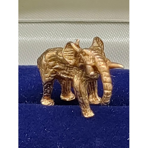 14 - A 9ct yellow gold miniature elephant figure pendant. [Missing hoop] [7.82grams]