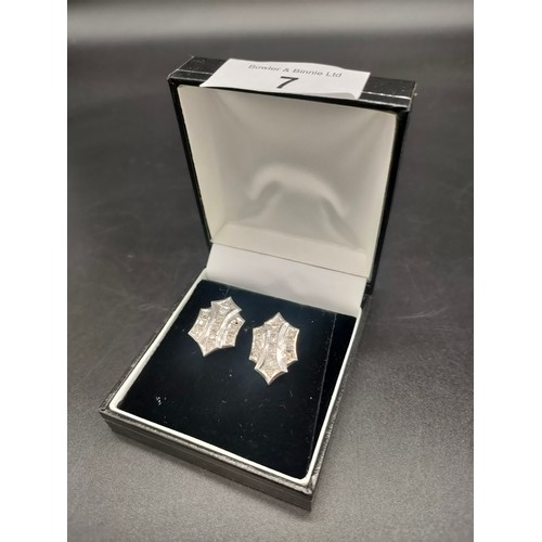 7 - A Pair of White gold [possibly Platinum] items of jewellery containing diamond stone settings. Appro... 