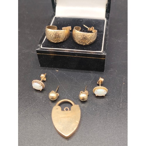 33 - A Selection of 9ct gold earrings and 9ct gold heart shaped locket. Includes a pair of 9ct and opal e... 