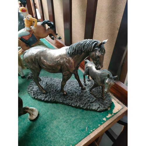 207 - A Collection of horse figures to include small rocking horse, jockey rider etc