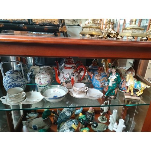 269 - A shelf of oriental porcelain includes tea pots, bud vase etc