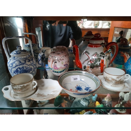 269 - A shelf of oriental porcelain includes tea pots, bud vase etc