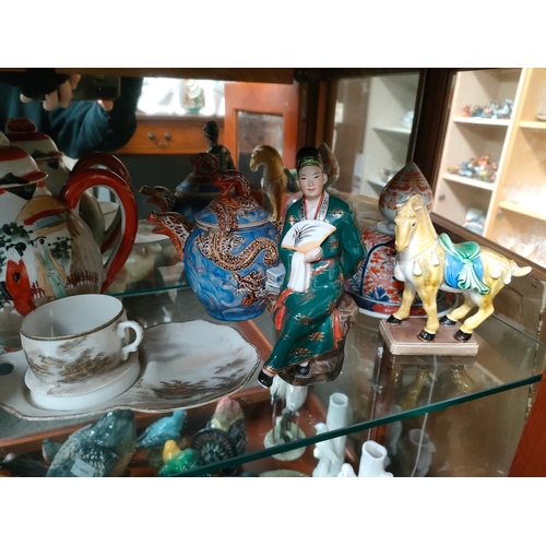 269 - A shelf of oriental porcelain includes tea pots, bud vase etc