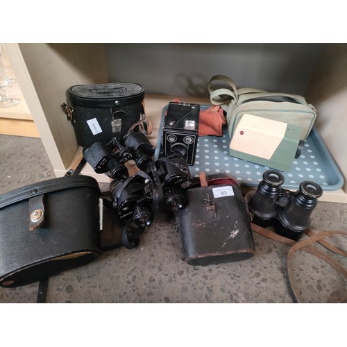 93 - A Shelf of Binoculars and cameras includes world war style binoculars with case unmarked