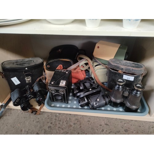 93 - A Shelf of Binoculars and cameras includes world war style binoculars with case unmarked