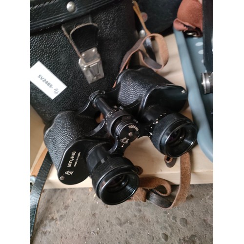 93 - A Shelf of Binoculars and cameras includes world war style binoculars with case unmarked