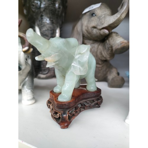 89 - A Shelf of Elephant figures includes Quail porcelain elephant head, Chinese Jade coloured elephant e... 