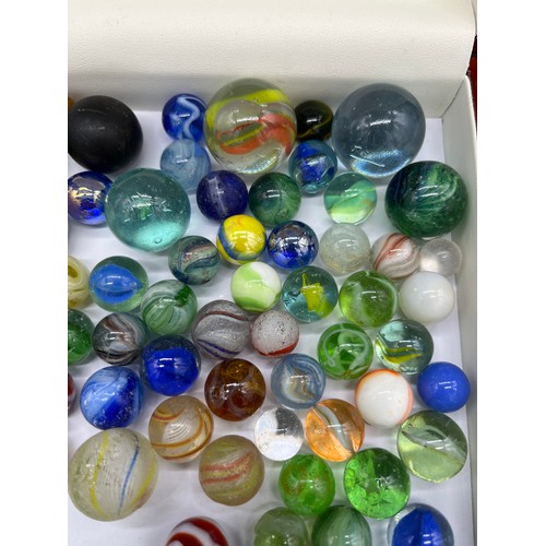 26 - A Selection of vintage and antique glass marbles to include Antique German twist cane marbles.