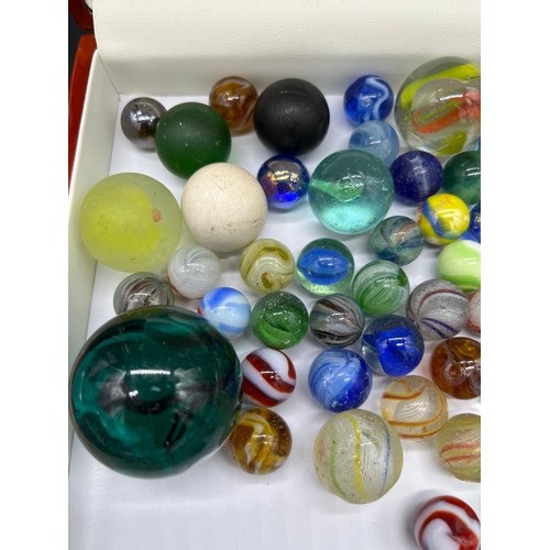 26 - A Selection of vintage and antique glass marbles to include Antique German twist cane marbles.