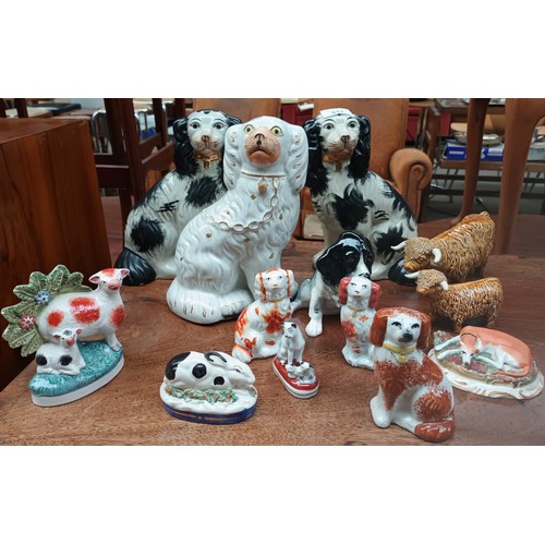 411 - A  collection of porcelain to include wally dogs, highland cows, rabbit, cats etc